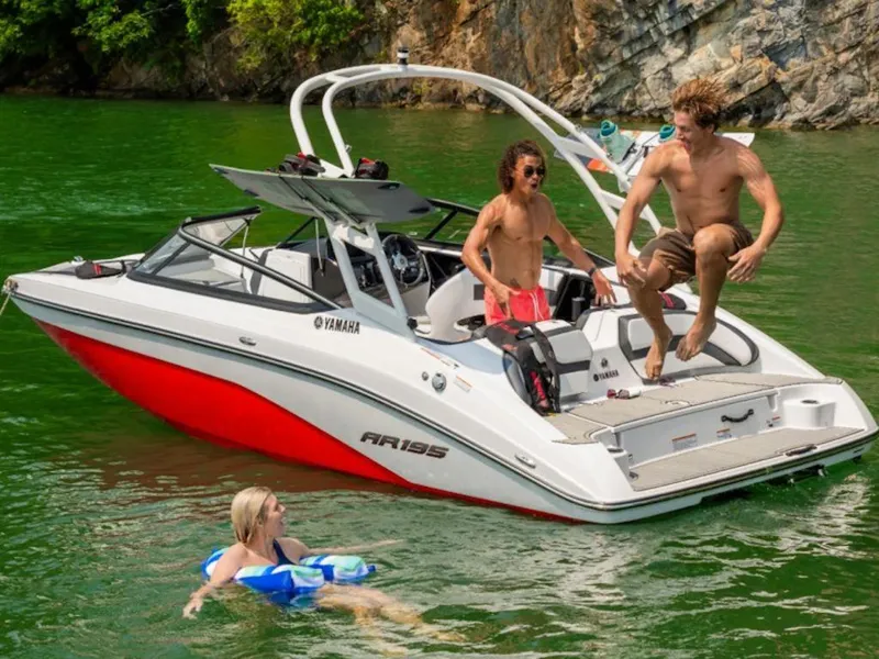 Slide: The Image of 2024 Yamaha Boats AR195 on a lake with people enjoying water activities. - 5