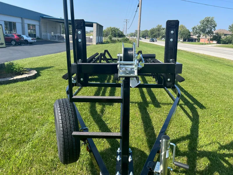 Slide: The Image of 2024 Pontoon Trailer on grass near a building and road. - 3