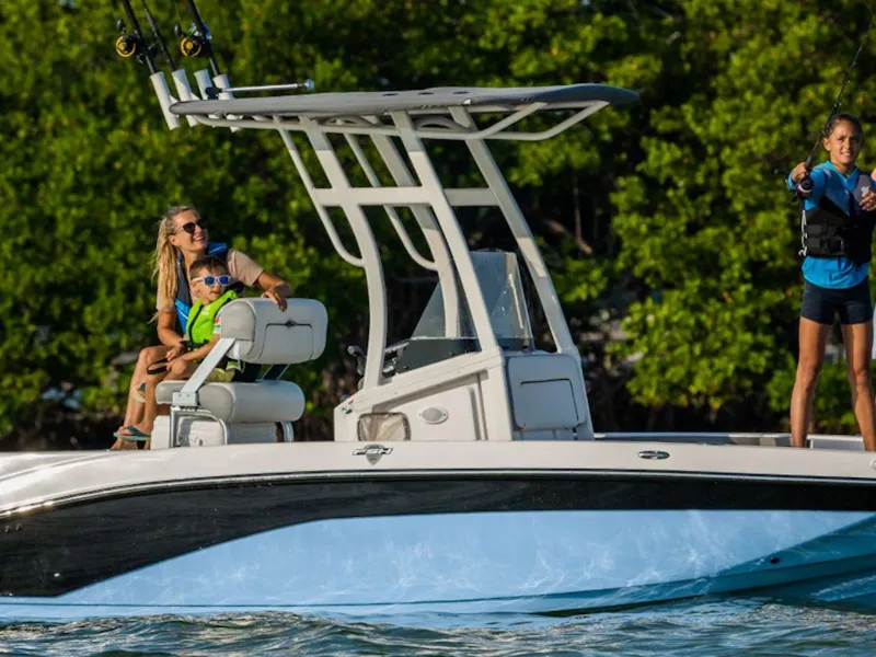Slide: The Image of 2024 Yamaha Boats 195 FSH Sport on water with family enjoying fishing. - 5