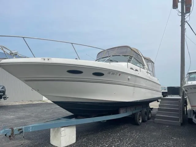 Slide: The Image of 1999 Sea Ray 310 DA boat on trailer in marina. - 2