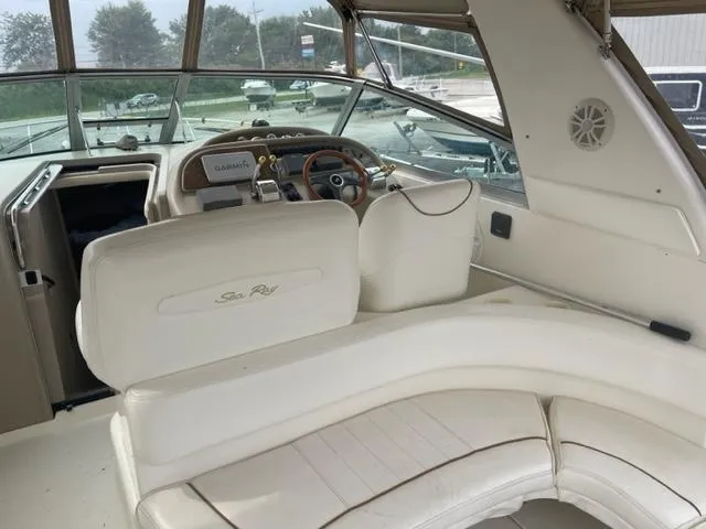 Slide: The Image of 1999 Sea Ray 310 DA boat interior with helm and seating area. - 5