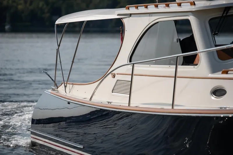 Slide: The Image of 2003 Hinckley Talaria 44 Express yacht cruising on calm waters. - 13