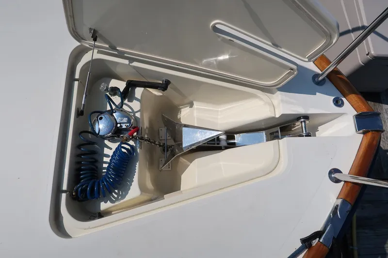 Slide: The Image of Anchor compartment of 2003 Hinckley Talaria 44 Express yacht with coiled hose and equipment. - 16