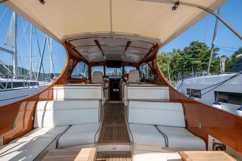 Slide: The Image of 2003 Hinckley Talaria 44 Express yacht interior with white seating and wooden accents. - 19