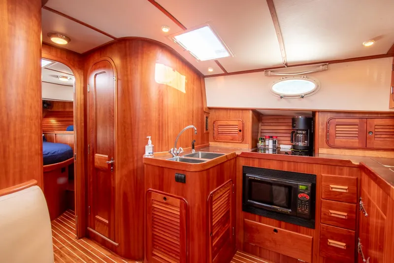 Slide: The Image of Luxurious 2003 Hinckley Talaria 44 Express yacht interior with wood finish and modern amenities. - 34