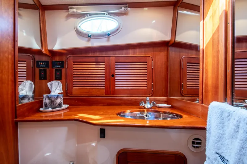 Slide: The Image of Luxurious 2003 Hinckley Talaria 44 Express yacht bathroom with wooden cabinetry and modern fixtures. - 40