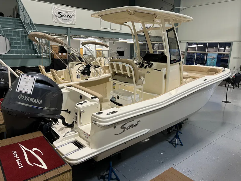 The Image of 2024 Scout 215 XSF boat with Yamaha engine on display in showroom. - 0
