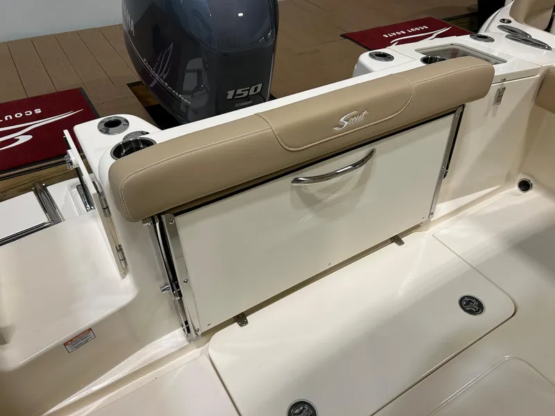 Slide: The Image of 2024 Scout 215 XSF boat with beige seating and Yamaha 150 engine. - 4