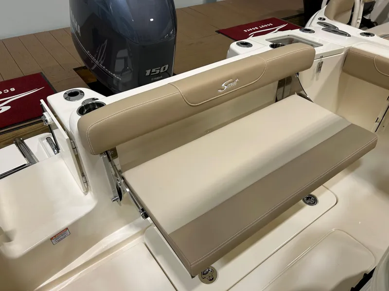 Slide: The Image of 2024 Scout 215 XSF boat with beige seating and 150 HP outboard motor. - 5