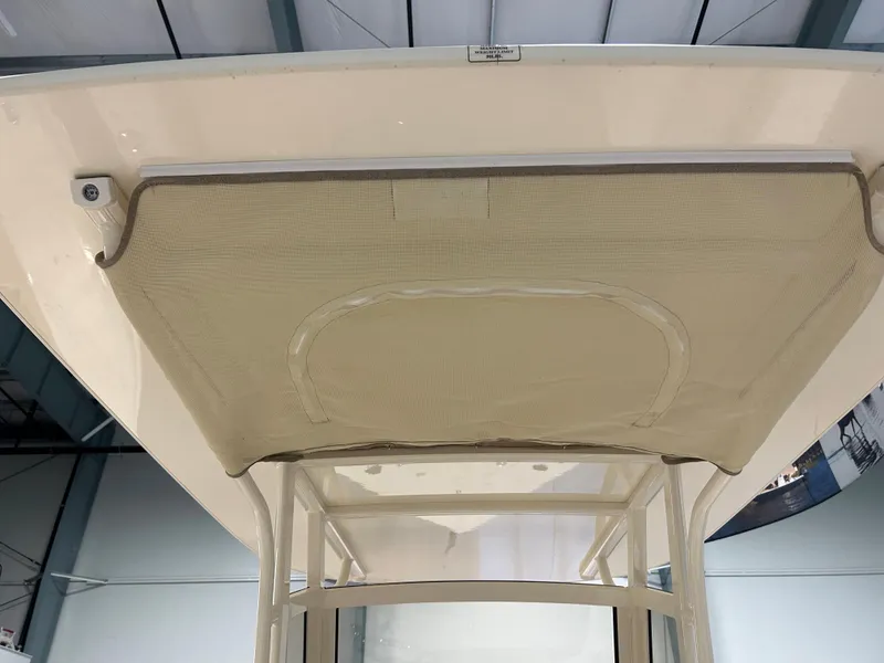Slide: The Image of 2024 Scout 215 XSF boat canopy and T-top frame in a showroom. - 6