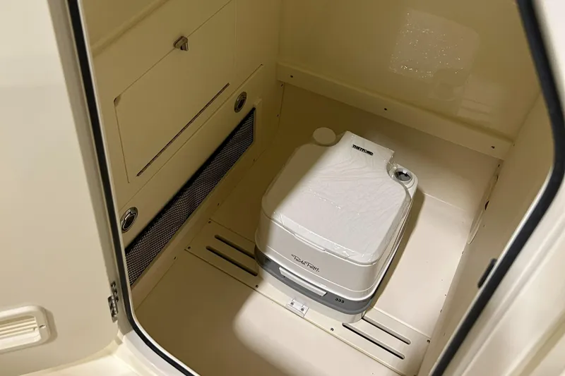 Slide: The Image of 2024 Scout 215 XSF boat interior with portable toilet. - 9