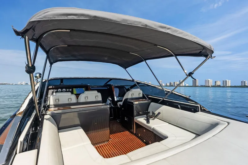 Slide: The Image of 2017 Riva Rivamare luxury yacht with canopy, white seating, and city skyline in the background. - 16