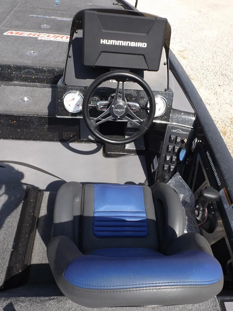 Slide: The Image of 2020 Falcon Boats 21TE dashboard with Humminbird electronics and blue captain's seat. - 3