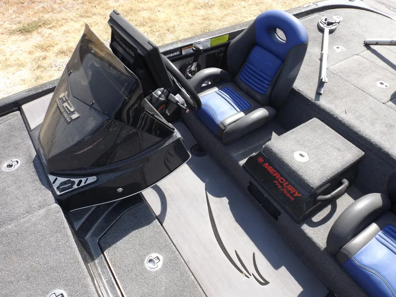 Slide: The Image of 2020 Falcon Boats 21TE cockpit with blue seats and Mercury controls. - 7