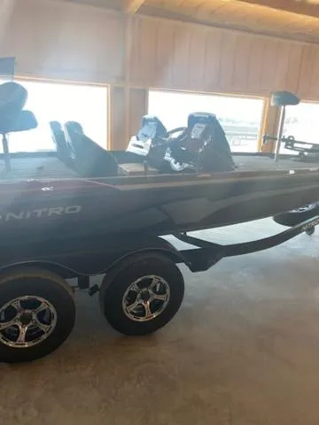 Slide: The Image of 2024 Nitro Z18 fishing boat with dual consoles and trailer in a showroom. - 10