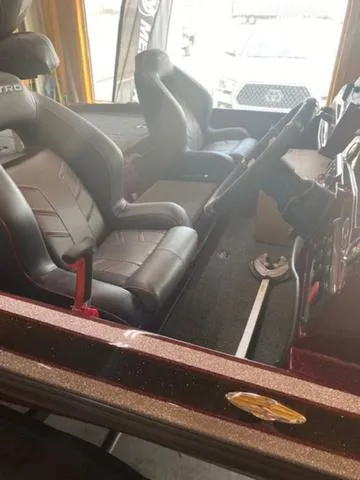 Slide: The Image of 2024 Nitro Z18 boat interior with black leather seats and steering console. - 13