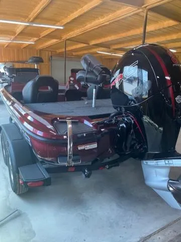 Slide: The Image of 2024 Nitro Z18 bass boat with powerful outboard motor in covered storage. - 5