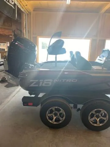Slide: The Image of 2024 Nitro Z18 boat in a garage with a powerful outboard motor. - 9