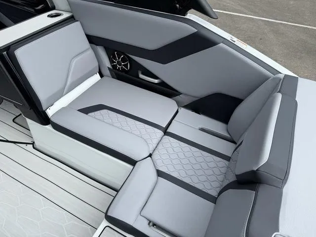 Slide: The Image of 2024 Yamaha Boats 255XE interior seating with modern design and gray upholstery. - 11
