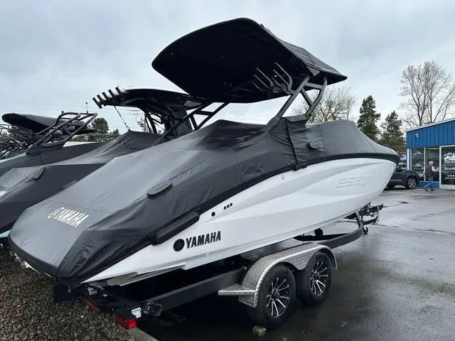 Slide: The Image of 2024 Yamaha Boats 255XE covered on trailer, parked outdoors. - 3