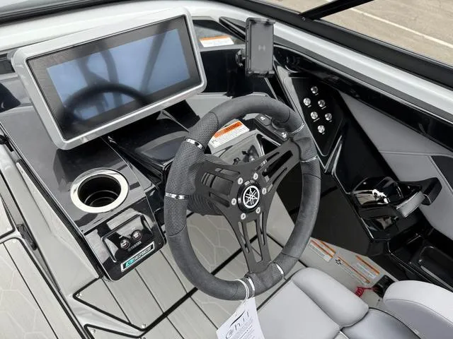 Slide: The Image of 2024 Yamaha Boats 255XE dashboard with steering wheel, touchscreen, and controls. - 8