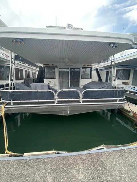 Slide: The Image of 2006 Sumerset Houseboat docked in a marina. - 1