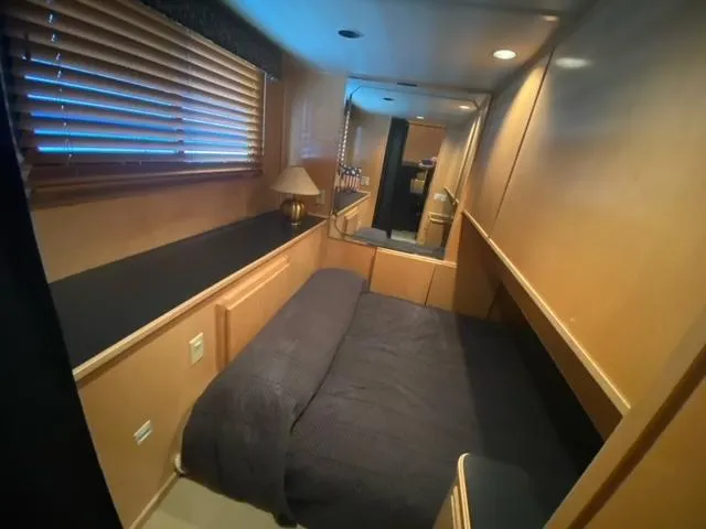 Slide: The Image of Cozy bedroom in a 2006 Sumerset Houseboat with wooden blinds and built-in storage. - 12