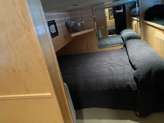 Slide: The Image of 2006 Sumerset Houseboat bedroom with wooden interior and cozy bed. - 14