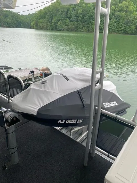 Slide: The Image of 2006 Sumerset Houseboat with a covered Sea-Doo jet ski on a lake. - 22