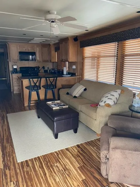 Slide: The Image of Interior of a 2006 Sumerset Houseboat with modern kitchen and cozy living area. - 3