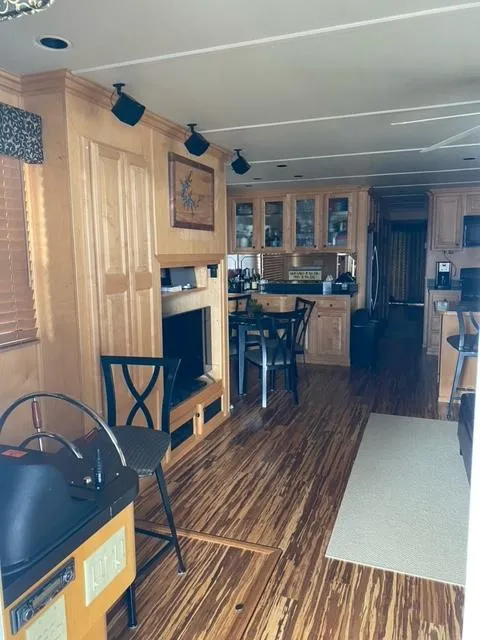 Slide: The Image of Interior of a 2006 Sumerset Houseboat with wooden flooring and modern kitchen. - 5