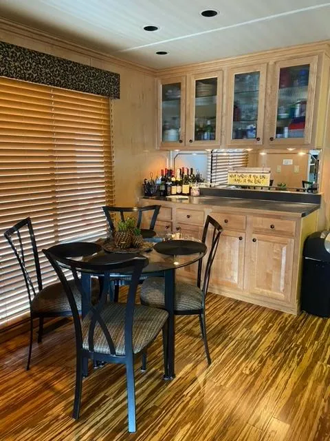 Slide: The Image of 2006 Sumerset Houseboat interior with dining area and wooden cabinetry. - 9