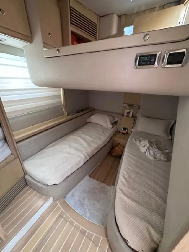 Slide: The Image of Interior cabin of 2006 Baia 63 Azzurra yacht with twin beds and modern amenities. - 10