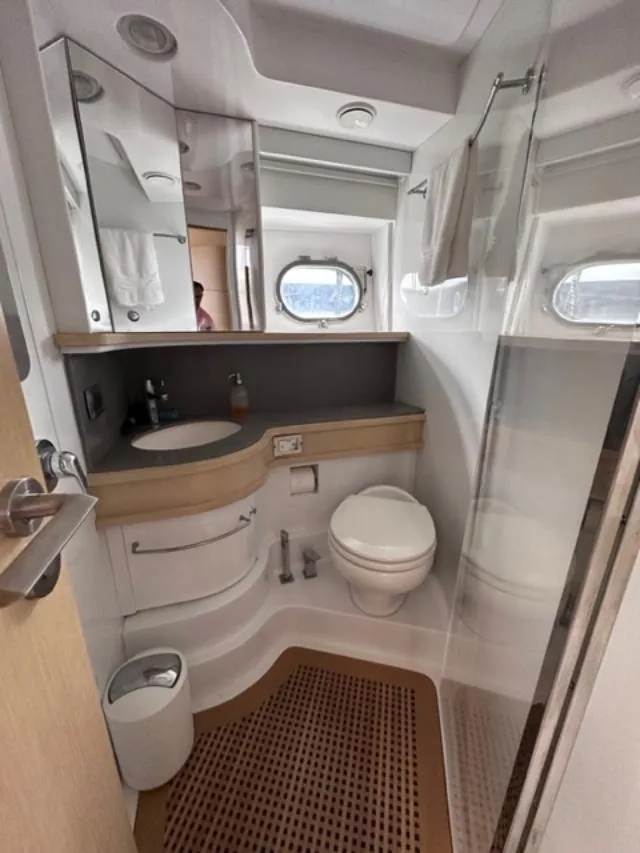 Slide: The Image of Modern bathroom on a 2006 Baia 63 Azzurra yacht with sink, toilet, and shower. - 11
