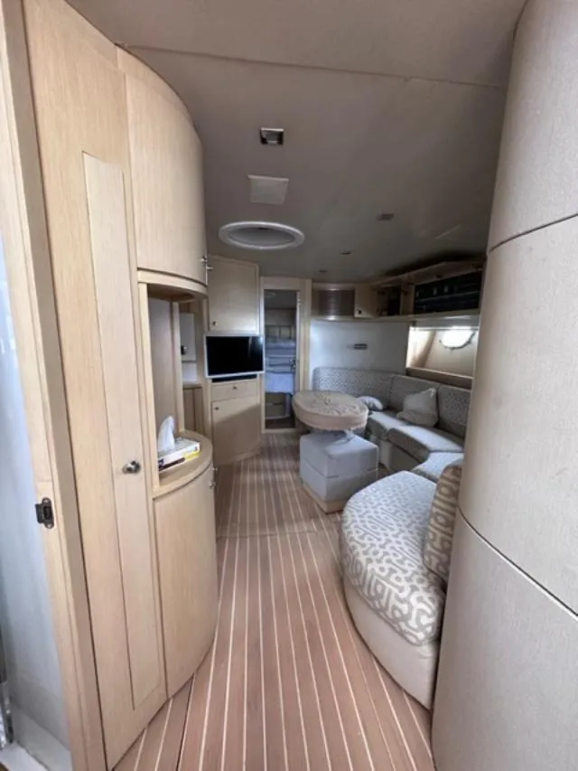 Slide: The Image of Interior of 2006 Baia 63 Azzurra yacht with modern furnishings and wood flooring. - 12