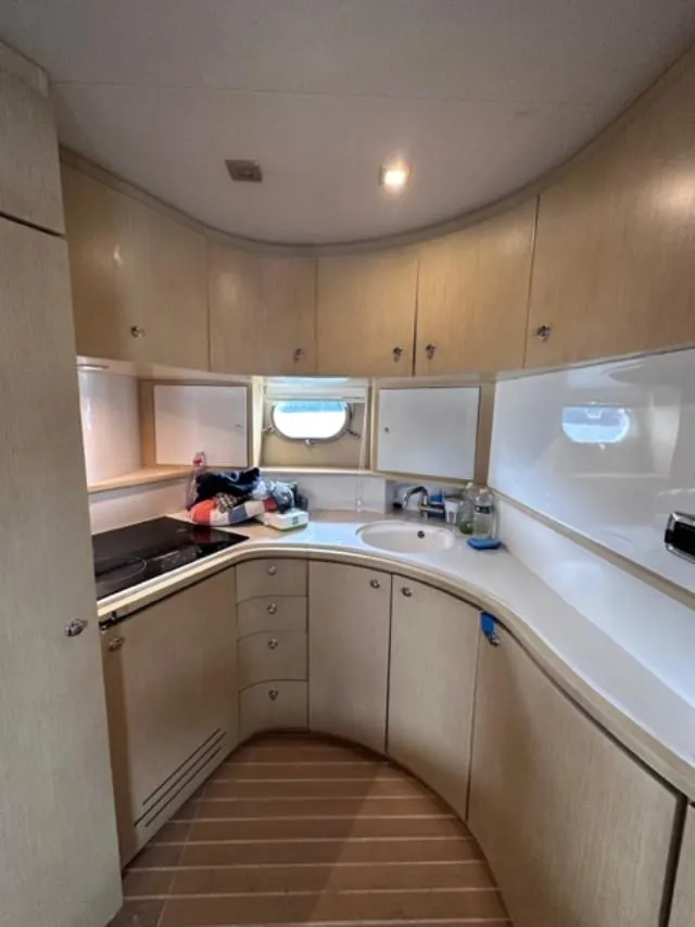 Slide: The Image of Modern kitchen in 2006 Baia 63 Azzurra yacht with wooden cabinets and white countertops. - 15