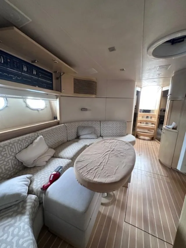 Slide: The Image of Interior of 2006 Baia 63 Azzurra yacht with cozy seating and wooden flooring. - 19
