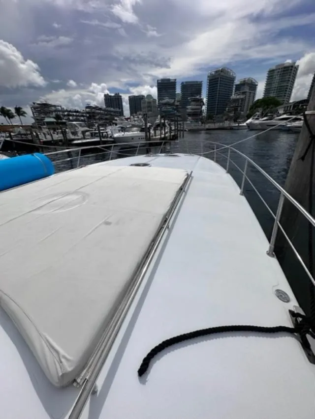 Slide: The Image of 2006 Baia 63 Azzurra yacht docked in a marina with city skyline. - 23