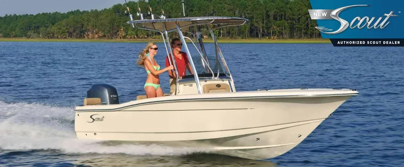 The Image of 2024 Scout 195 Sportfish boat cruising on a lake with two passengers. - 0