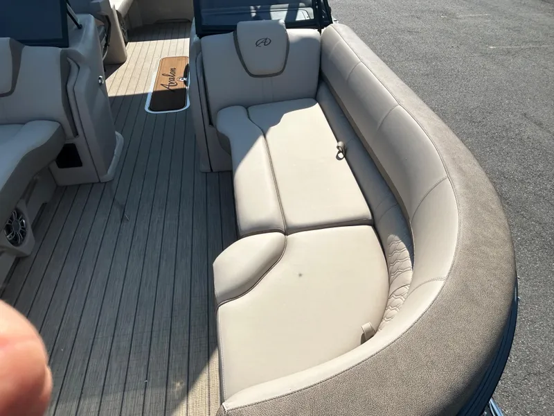 Slide: The Image of 2024 Avalon LSZ 2385 EL boat interior with beige seating and wood flooring. - 10
