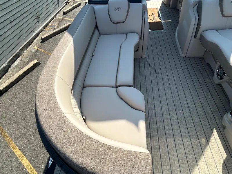 Slide: The Image of 2024 Avalon LSZ 2385 EL boat interior with beige seating and gray flooring. - 11