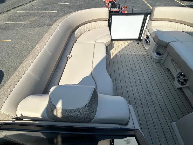 Slide: The Image of 2024 Avalon LSZ 2385 EL pontoon boat interior with beige seating and wood-like flooring. - 15