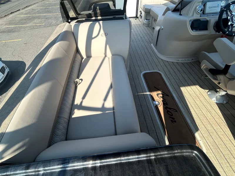 Slide: The Image of 2024 Avalon LSZ 2385 EL boat interior with beige seating and wood flooring. - 21