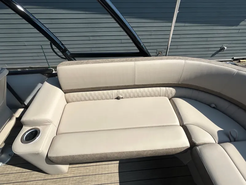 Slide: The Image of 2024 Avalon LSZ 2385 EL boat interior with beige seating and cup holder. - 22