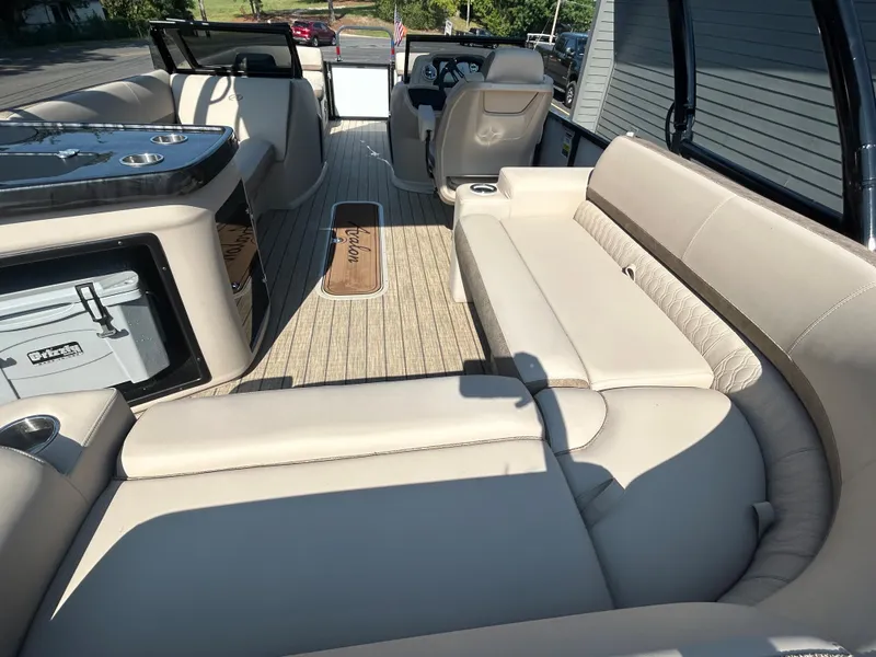Slide: The Image of 2024 Avalon LSZ 2385 EL luxury pontoon boat interior with beige seating and modern amenities. - 25