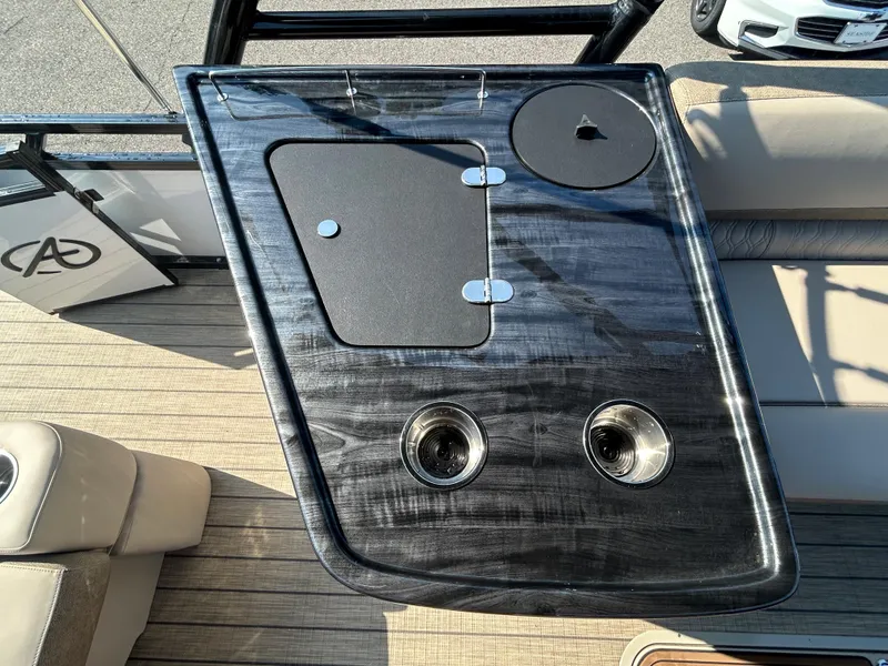 Slide: The Image of 2024 Avalon LSZ 2385 EL boat console with cup holders and storage compartments. - 26