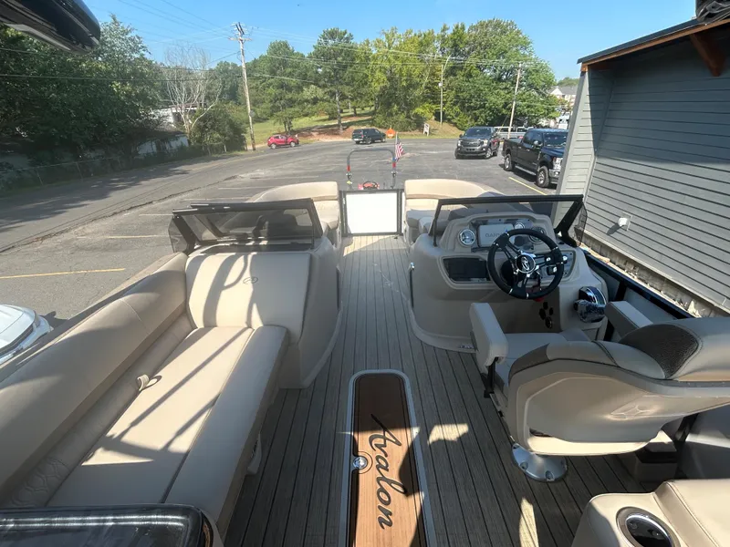 Slide: The Image of 2024 Avalon LSZ 2385 EL pontoon boat interior with beige seating and modern dashboard. - 29