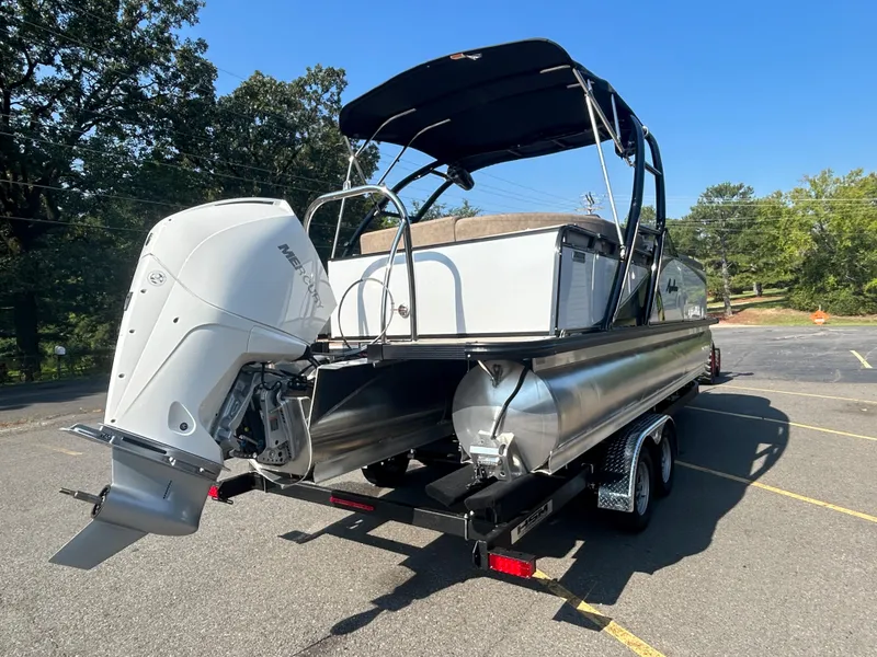 Slide: The Image of 2024 Avalon LSZ 2385 EL pontoon boat on trailer with outboard motor. - 3