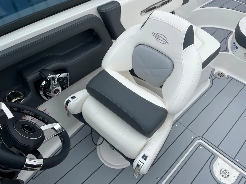 Slide: The Image of 2024 Chaparral 247 SSX boat interior with luxury captain's chair and steering wheel. - 12