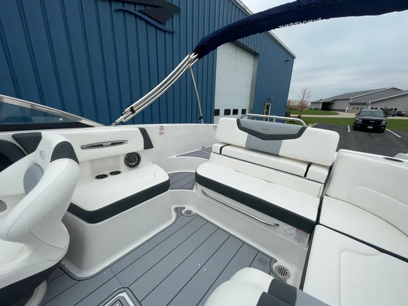 Slide: The Image of 2024 Chaparral 247 SSX boat interior with white and gray seating. - 13